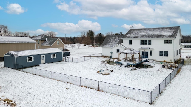 snow covered house featuring a gazebo