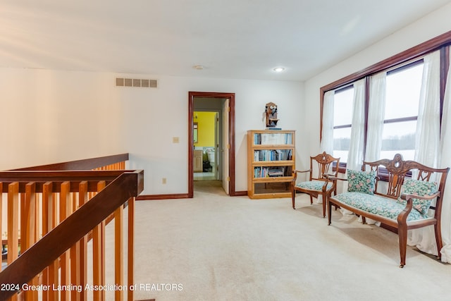 living area with light colored carpet