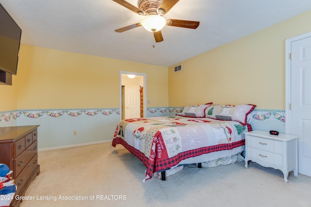 bedroom featuring light colored carpet and ceiling fan