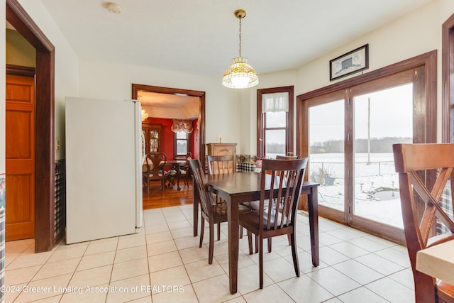 dining space featuring light tile patterned flooring