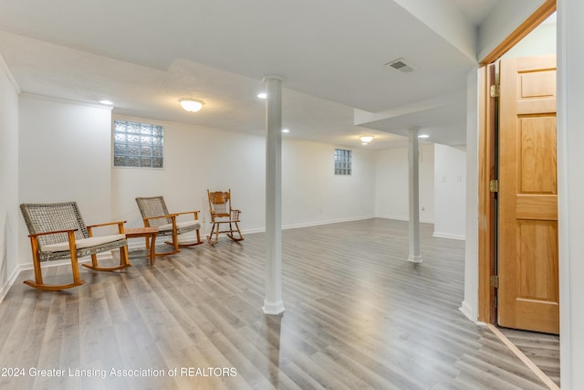 basement with light hardwood / wood-style flooring