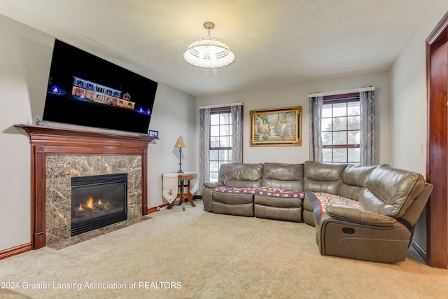 carpeted living room featuring a fireplace and plenty of natural light