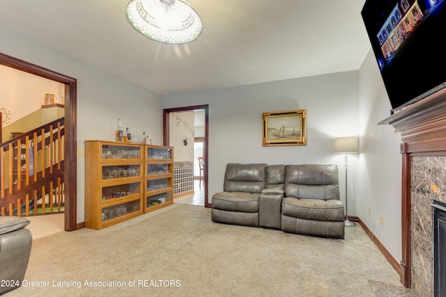 carpeted living room featuring a tiled fireplace