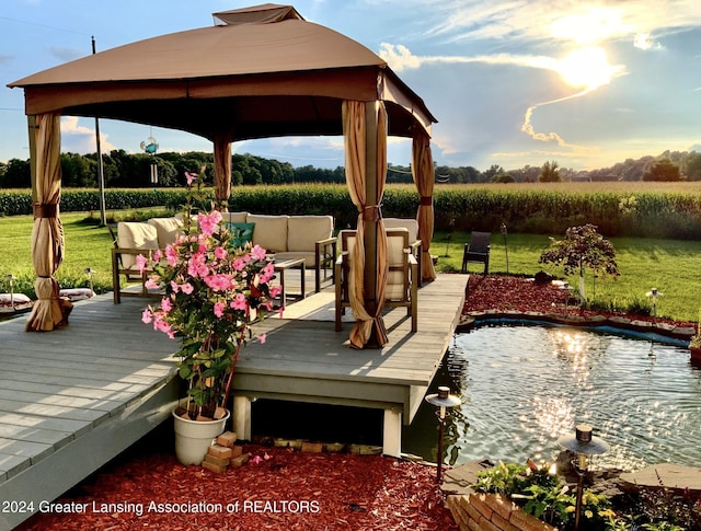 wooden terrace with a gazebo and outdoor lounge area