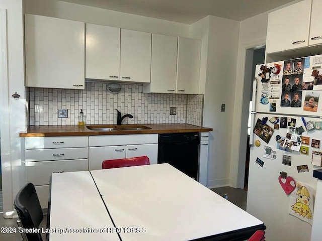 kitchen with backsplash, dishwasher, white refrigerator, and sink