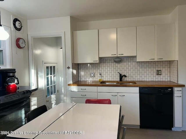 kitchen with backsplash, sink, white cabinets, and black appliances