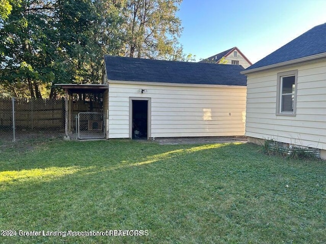 view of outbuilding featuring a lawn