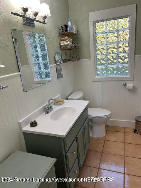 bathroom featuring tile patterned flooring, vanity, and toilet