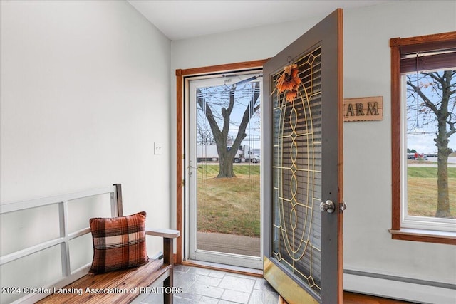 doorway to outside featuring a baseboard radiator and a healthy amount of sunlight