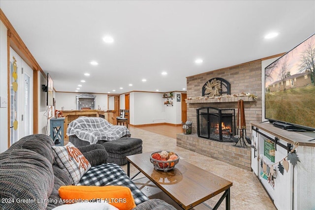 living room featuring ornamental molding and a fireplace