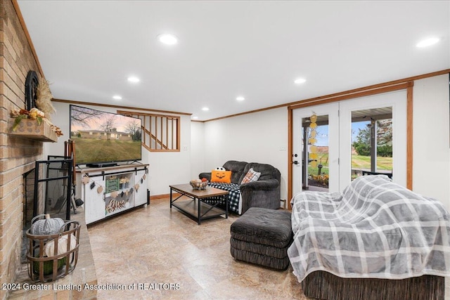 living room with crown molding and a fireplace