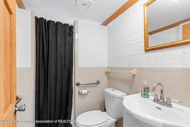 bathroom with walk in shower, sink, tile walls, and toilet