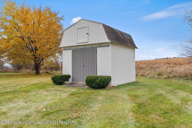 view of outbuilding featuring a lawn