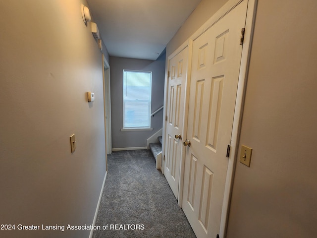 corridor featuring dark colored carpet