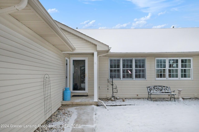 view of snow covered property entrance