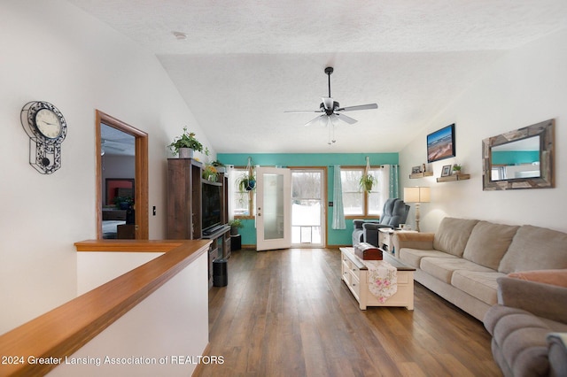 living room featuring a textured ceiling, ceiling fan, dark hardwood / wood-style flooring, and vaulted ceiling