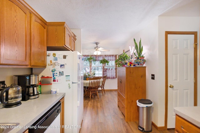 kitchen with ceiling fan, white fridge, light hardwood / wood-style floors, a textured ceiling, and dishwashing machine