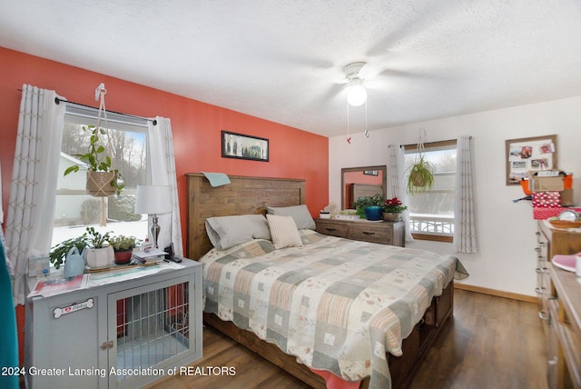 bedroom featuring a textured ceiling, dark hardwood / wood-style flooring, and ceiling fan