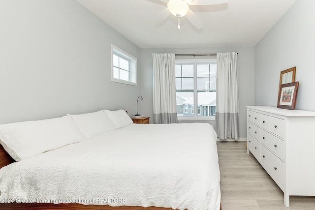 bedroom with multiple windows, ceiling fan, and light hardwood / wood-style flooring