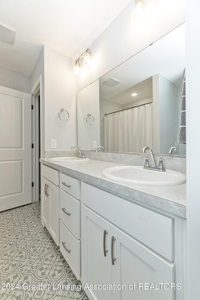 bathroom with vanity and tile patterned floors