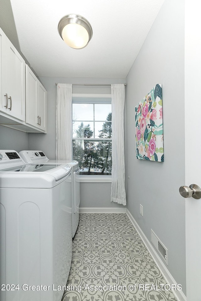 washroom with cabinets and independent washer and dryer