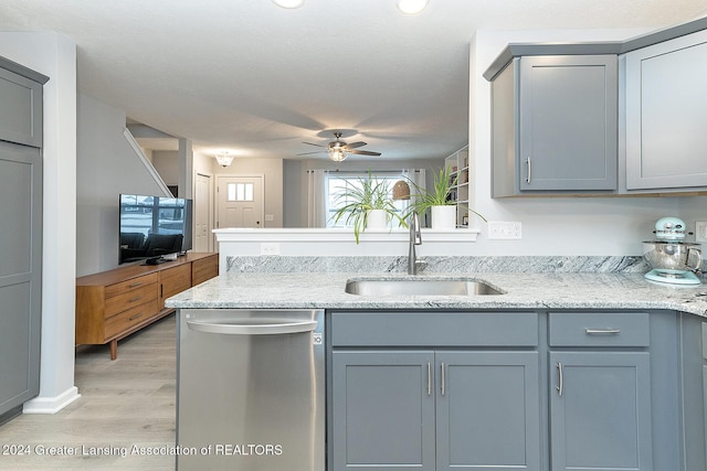 kitchen with gray cabinetry, ceiling fan, sink, light hardwood / wood-style flooring, and stainless steel dishwasher