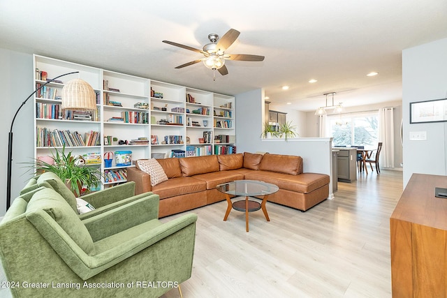 living room with light hardwood / wood-style flooring and ceiling fan