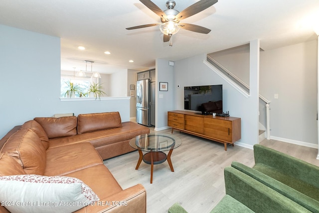 living room with light wood-type flooring and ceiling fan