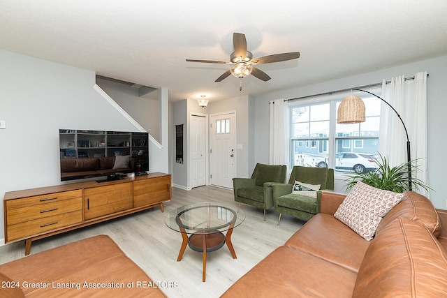 living room featuring ceiling fan and hardwood / wood-style floors