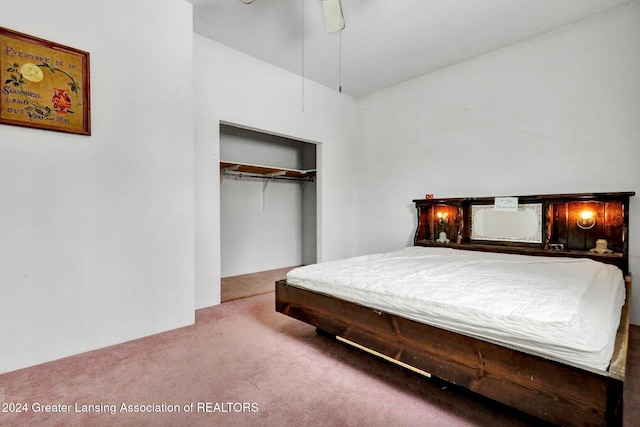 carpeted bedroom with ceiling fan and a closet