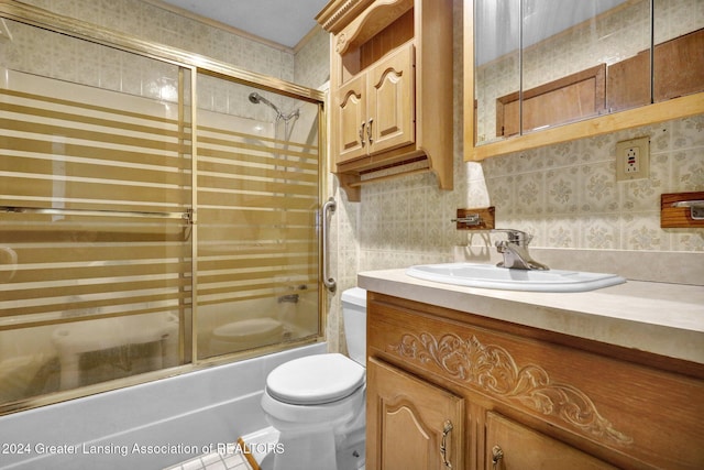 full bathroom featuring shower / bath combination with glass door, decorative backsplash, vanity, and toilet