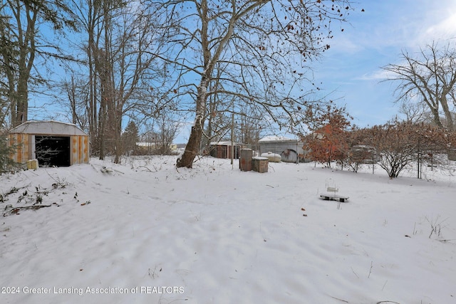 snowy yard with an outdoor structure