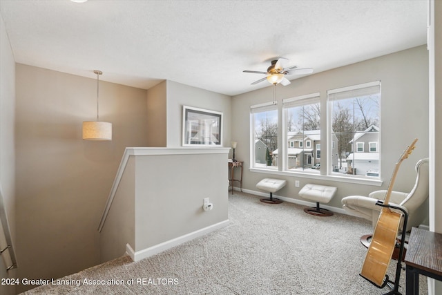 interior space featuring carpet flooring and ceiling fan