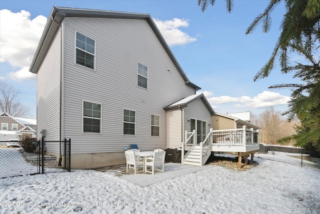 snow covered property featuring a deck