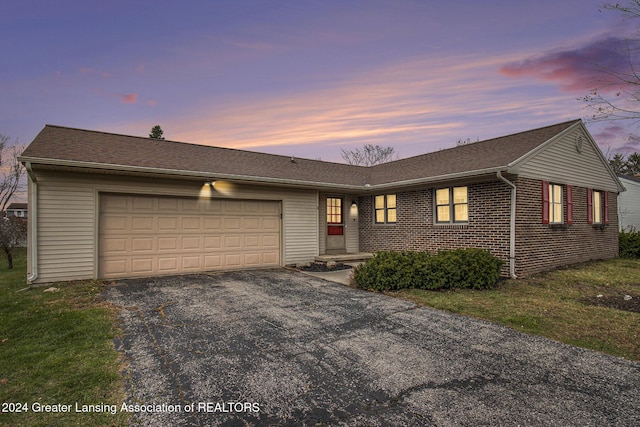 ranch-style house featuring a garage