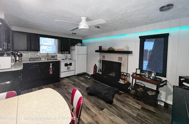 kitchen featuring sink, white appliances, ceiling fan, a textured ceiling, and dark hardwood / wood-style flooring
