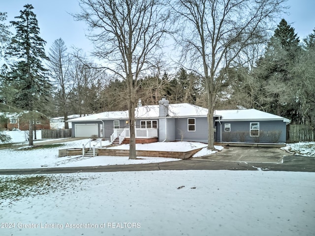 view of front of property featuring a garage and an outdoor structure