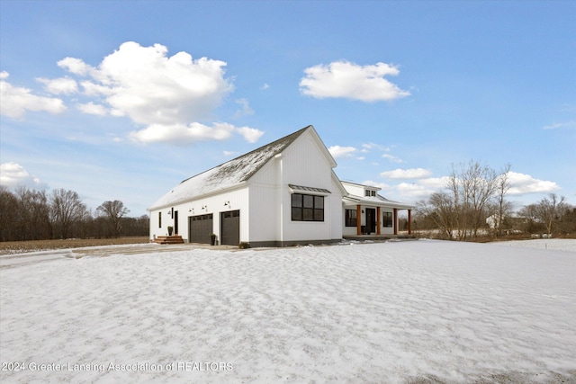 rear view of property featuring a garage