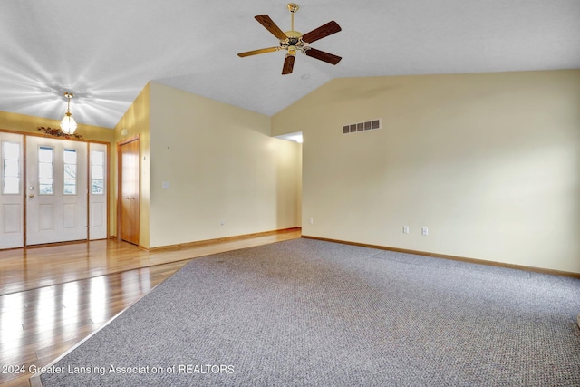 unfurnished room with ceiling fan, light hardwood / wood-style floors, and vaulted ceiling