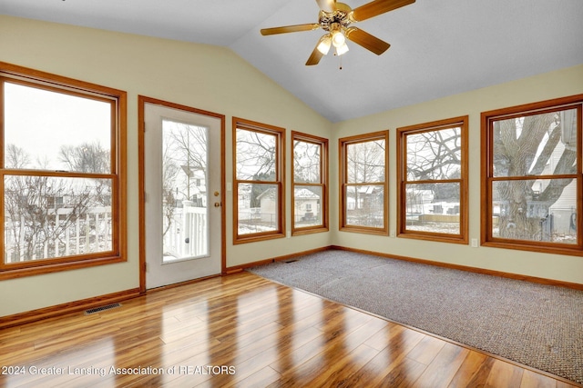 unfurnished sunroom featuring ceiling fan and vaulted ceiling