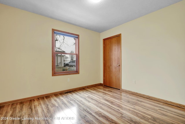 spare room with light hardwood / wood-style flooring