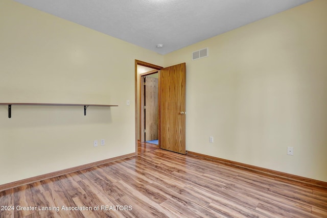 unfurnished room with light hardwood / wood-style flooring