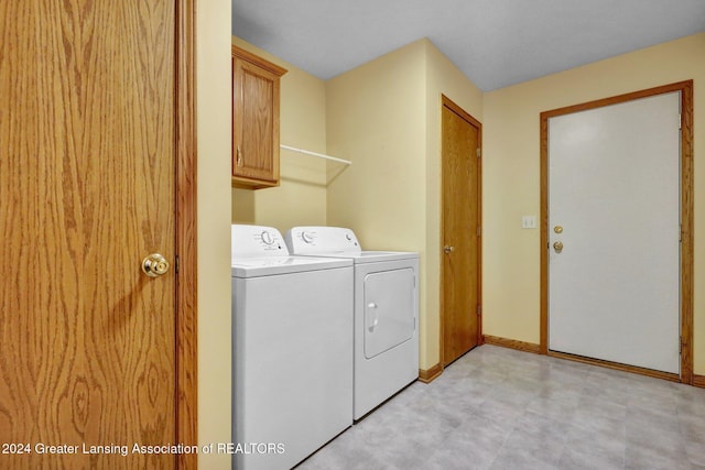 washroom with cabinets and separate washer and dryer