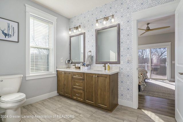 bathroom featuring vanity, ceiling fan, and toilet