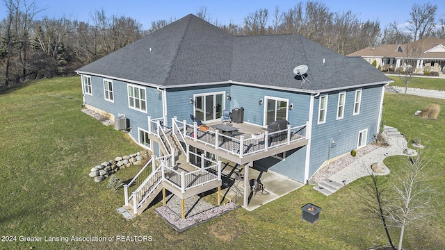 rear view of house featuring central AC unit, a patio area, a yard, and a wooden deck