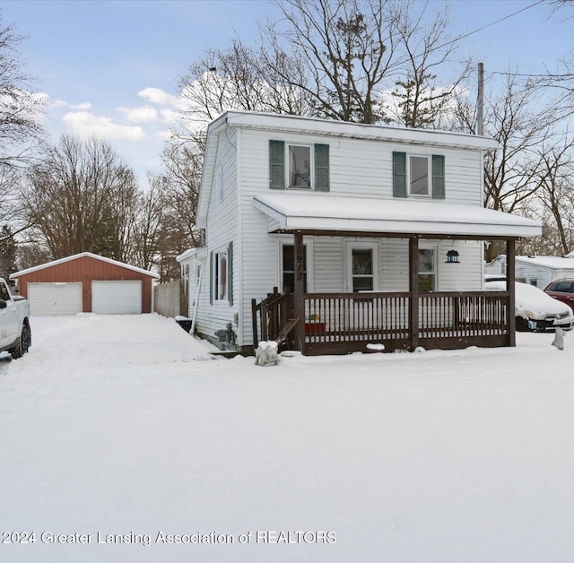 front of property with a porch, a garage, and an outdoor structure