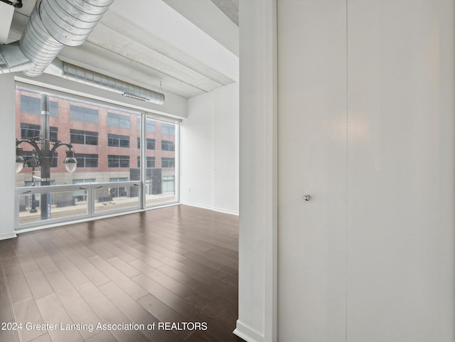 empty room featuring a chandelier and hardwood / wood-style flooring