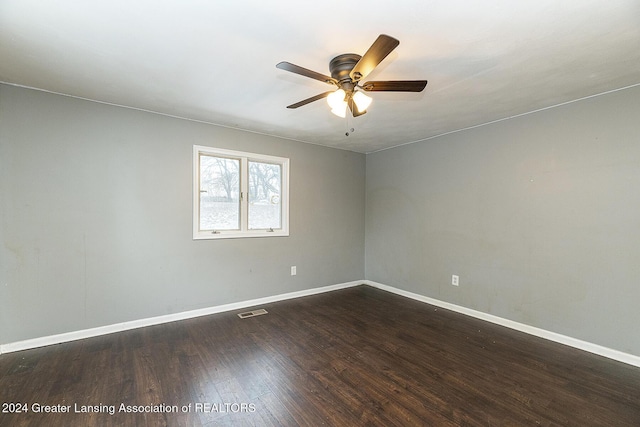 spare room with dark hardwood / wood-style floors and ceiling fan