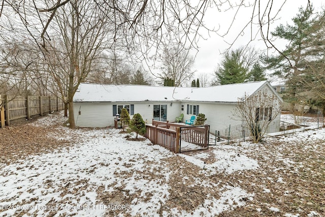 snow covered property featuring a wooden deck