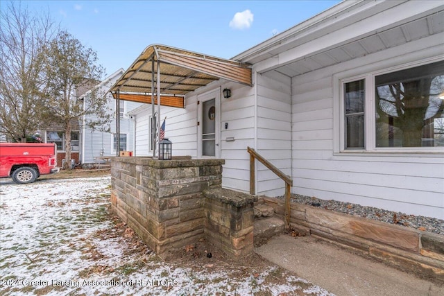 view of snow covered property entrance